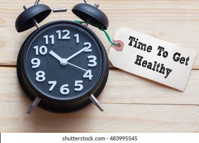 Time To Get Healthy Words Written On Tag Label With Clock On Wood Background,Conceptual