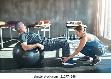 Time To Get Up And Get Moving. Shot Of A Senior Man Working Out With His Physiotherapist.