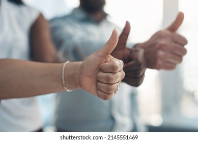 Time To Go All The Way With Our Business. Cropped Shot Of An Unrecognizable Group Of Businesspeople Standing Together And Making A Thumbs-up Gesture In The Office.