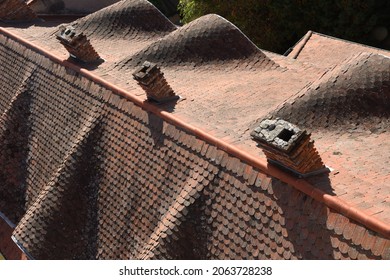 Time honored tiled roof and brick chimneys, top view - Shutterstock ID 2063728238