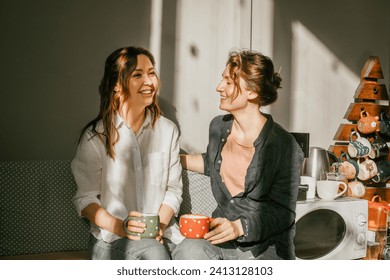 Time for intimate conversations: two women drinking tea in the sunshine in a cozy environment Girls friends talking over a cup of coffee - Powered by Shutterstock