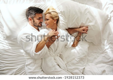 Time is just for us, no children. Intimacy is full of passion and love in a hotel room. A beautiful blonde and handsome man wakes up and cuddles on a sunny morning. Lovely sensitive memories in hotel
