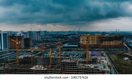 Time Lapse Construction Site Against The Backdrop Of The Cityscape, Cranes And Builders Are Working