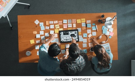 Time lapse of creative designer working together brainstorming idea by using sticky notes at meeting table with color palettes. Aerial view of smart team choosing icon graphic from tablet. Symposium. - Powered by Shutterstock