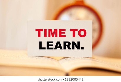 TIME TO LEARN against the background of a clock with a book open in the middle.