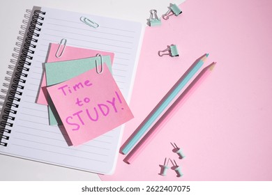 Time to learn - written message in the workplace. Stationery, notebook, paper clips and sticky notes. Concept of learning