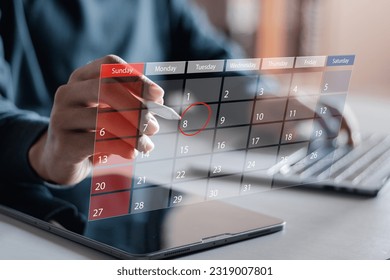 Time management concept. Businessman manages time for effective work. Calendar on the virtual screen interface. Highlight appointment reminders and meeting agenda on the calendar.