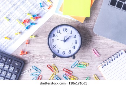 Time management concept. Composition with alarm clock on wooden table with laptop computer, stationary and calculator, top view above - Powered by Shutterstock