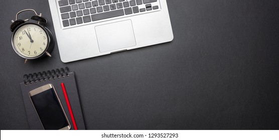 Time Management Concept. Computer Laptop And Alarm Clock On Black Color Office Desk, Banner, Top View, Copy Space