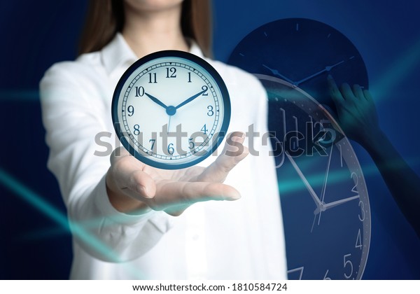 Time\
management concept. Woman with clock,\
closeup