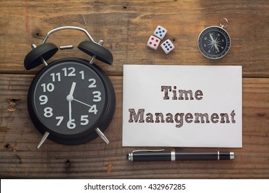 Time Management Written On Paper With Wooden Background Desk,clock,dice,compass And Pen.Top View Conceptual