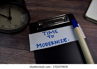 Time To Modernize write on sticky notes isolated on the table. - Shutterstock ID 1705379878