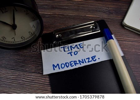 Time To Modernize write on sticky notes isolated on the table.