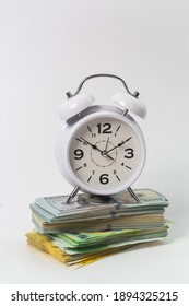 Time Is Money Concept, Us Dollars, Euro Banknotes And Alarm Clock