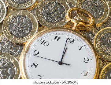 Time And Money, Gold Watch Near Midnight On A Pile Of Coins