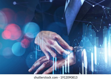 Time is money. Trader, businessman checking time while looking at his watch and standing over hologram financial charts. Stock market prediction and wealth management. Double exposure