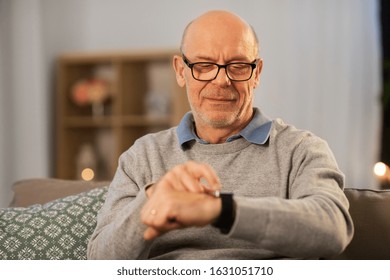 time, morning and people concept - senior man looking at wristwatch at home in evening - Powered by Shutterstock