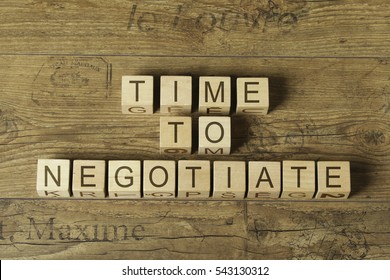 Time To Negotiate Text On Cubes On Wooden Background