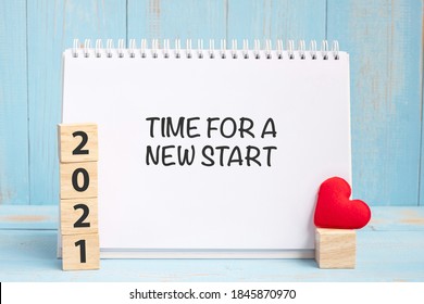 Time For A New Start Words And 2021 Cubes With Red Heart Shape Decoration On Blue Wooden Table Background. New Year NewYou, Goal, Resolution, Health, Love And Happy Valentine’s Day Concept