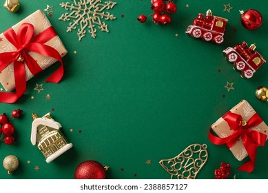 Time for New Year delights! Top view of gifts, baubles, snowflake, and other imaginative Christmas tree toys on green canvas. Mistletoe berries and confetti scattered, leaving space for your message