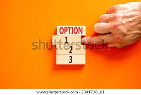 Time to option 1 symbol. Concept word Option 1 2 3 on wooden block. Businessman hand. Beautiful orange table orange background. Business planning and time to option 1 concept. Copy space.