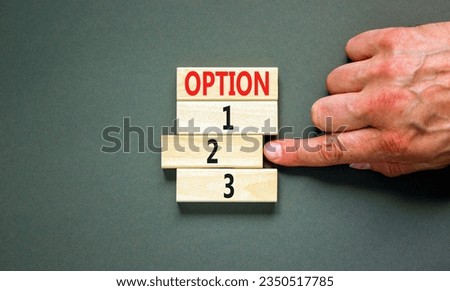 Time to option 2 symbol. Concept word Option 1 2 3 on wooden block. Businessman hand. Beautiful grey table grey background. Business planning and time to option 2 concept. Copy space.