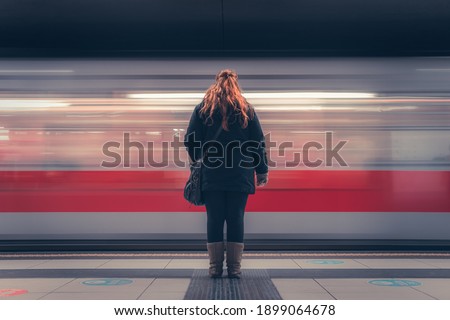 time passes as the train passes, woman waiting in the subway after leaving work to get home