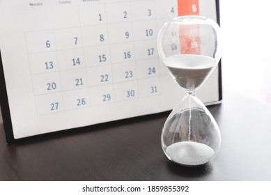 Time Passing Concept, Time Slipping Away. Hourglass And The Calendar