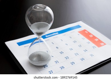 Time Passing Concept, Time Slipping Away. Hourglass And The Calendar