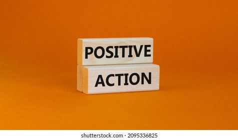 Time to positive action symbol. Wooden blocks with concept words 'Positive action'. Beautiful orange background. Business and positive action concept. Copy space.
