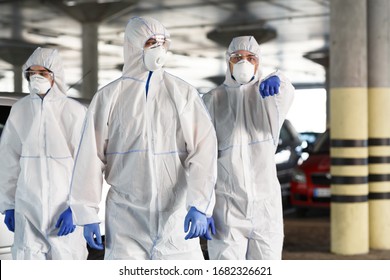 Time to protect yourself, stay at home. Men in hazmat suits pointing at you, epidemic, quarantine, copy space - Powered by Shutterstock