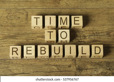 Time To Rebuild Text On Wooden Cubes On A Wooden Background