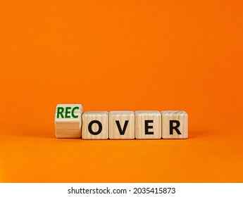 Time To Recover Symbol. Turned A Wooden Cube And Changed The Word 'over' To 'recover'. Beautiful Orange Table, Orange Background. Business, Over Or Recover Concept. Copy Space.