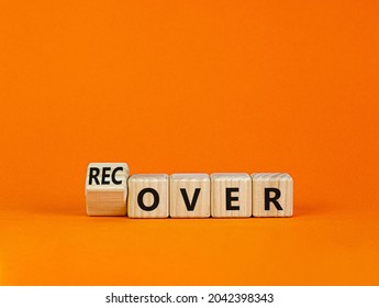 Time To Recover Symbol. Turned A Wooden Cube And Changed The Word 'over' To 'recover'. Beautiful Orange Table, Orange Background. Business, Over Or Recover Concept. Copy Space.