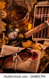 Time To Relax! A Complete Set Of Male Pleasures: A Glass Of Whiskey, Havana Cigars In Open Humidor Box, Sunglasses And Pocket Watch In Memory Of A Trip To Paris