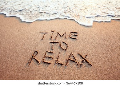 time to relax, concept written on sandy beach - Shutterstock ID 364469108