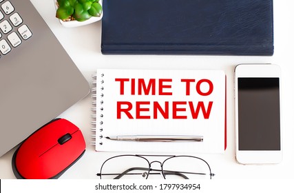 Time to Renew written on a notebook with office tools