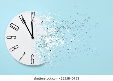 Time running out. Clock dissolving on light blue background