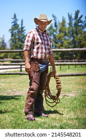 Time to rustle up some outlaws. A mature cowboy outdoors on his farm. - Shutterstock ID 2145548201