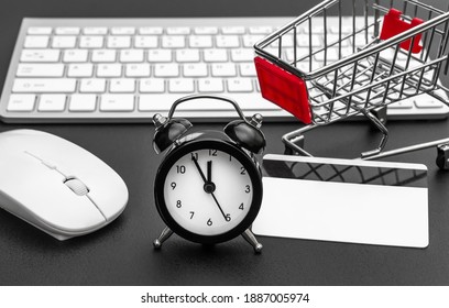 Time To Shopping Online. Clock With Shopping Cart, Credit Card And Computer Keyboard On Black Desk.