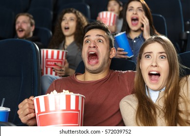 Time For Some Scare. Young Couple Watching A Horror Movie Together At The Cinema Embracing And Screaming Looking Terrified And Scared Thriller Premiere Entertainment Leisure Dating Togetherness Love