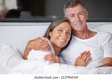 Time For Some Snuggling. Portrait Of A Loving Mature Couple Cuddling In Bed.