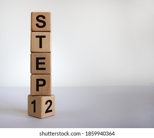 Time to step 2. Turned a cube and changed the expression 'step 1' to 'step 2'. Beautiful white background. Business and next step concept, copy space.