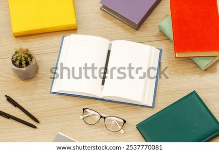 Time To Study. Above view arrangement of educational books on the wooden desk, open notebook with pencil, flat lay