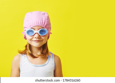 Time To Swim. Funny Little Girl In Swimsuit, Cap, And Glasses Standing On Yellow Background.