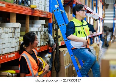 Time For A Tea Break Concept. Asian Male And Female Warehouse Industrial Factory Energy Engineer Drinking Water Sitting On Stair Warehouse Office Factory Workplace. Professional Engineer Team Working.