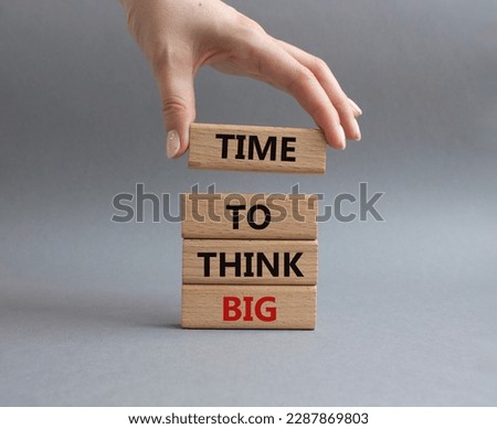 Time to think big symbol. Wooden blocks with words Time to think big. Beautiful grey background. Businessman hand. Business and Time to think big concept. Copy space.
