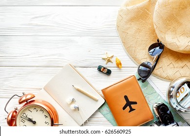 Time To Travel Concept, Space For Text. Map Camera Passport Money Phone With Empty Screen Sunglasses And Clock Hat Shells Car Toy On White Wooden Background. Hello Holiday, Planning Vacation