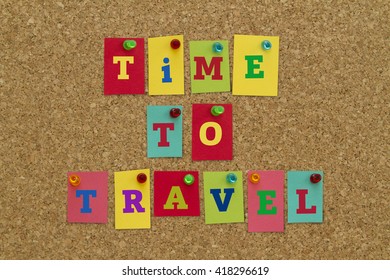 TIME TO TRAVEL Message Written On Colorful Sticky Notes Pinned On Cork Board.