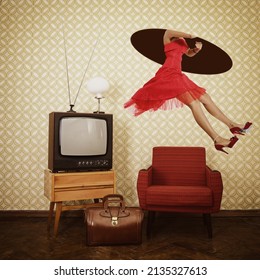 Time travel. Young woman wearing elegant red dress lands through hole in space in vintage room with old fashioned armchair, retro tv, lamp, bag over oblolete wallpaper 60-70 years of the 20th century